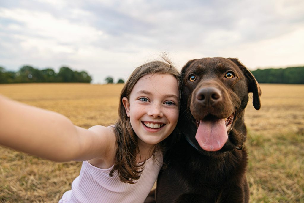 Girl taking a selfie with her pet dog